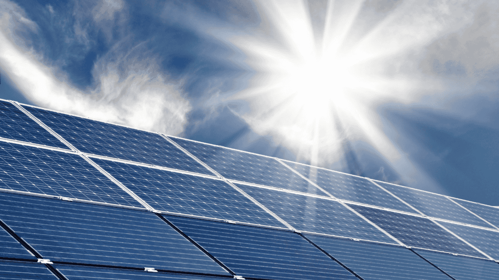solar-panels-with-sun-shining-in-background
